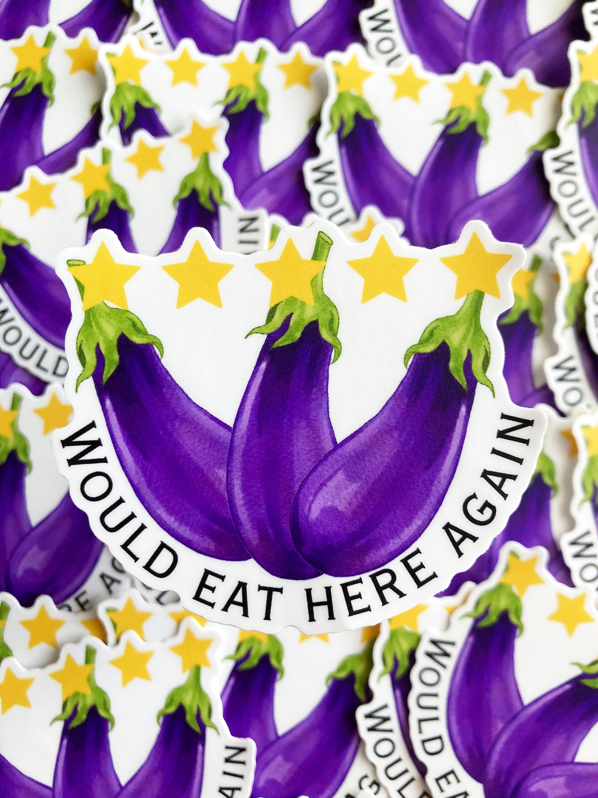 A set of stickers with 5 yellow stars above 3 eggplants with the text ‘would eat here again’