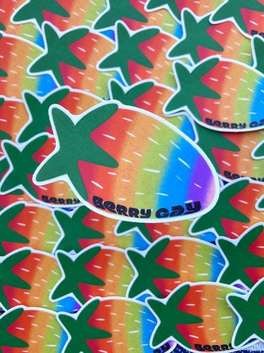 Collection of stickers. Each sticker is a drawing of a rainbow strawberry with the text ‘berry gay’